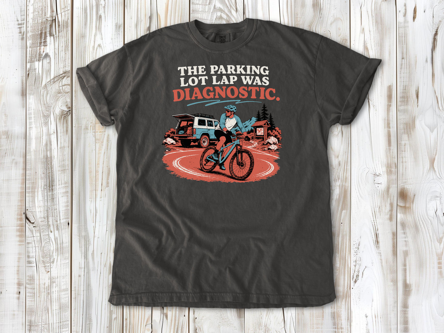 Ivory garment-dyed tee with The Parking Lot Lap Was Diagnostic mountain biking graphic.