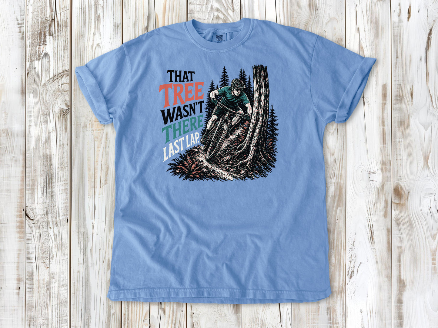 Pepper garment-dyed tee with That Tree Wasn't There Last Lap mountain bike trail graphic.