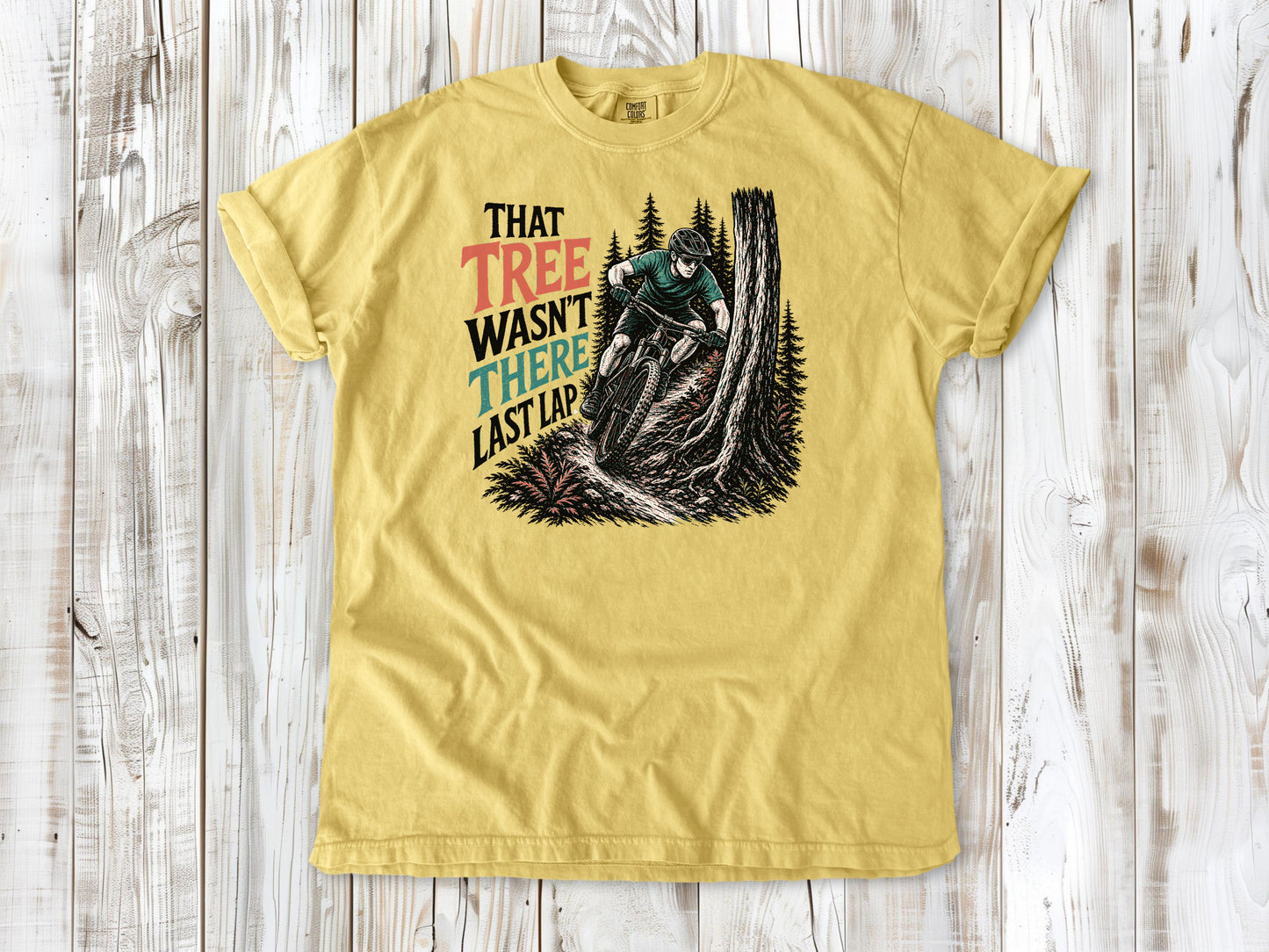 Grey garment-dyed tee with That Tree Wasn't There Last Lap mountain bike trail graphic.