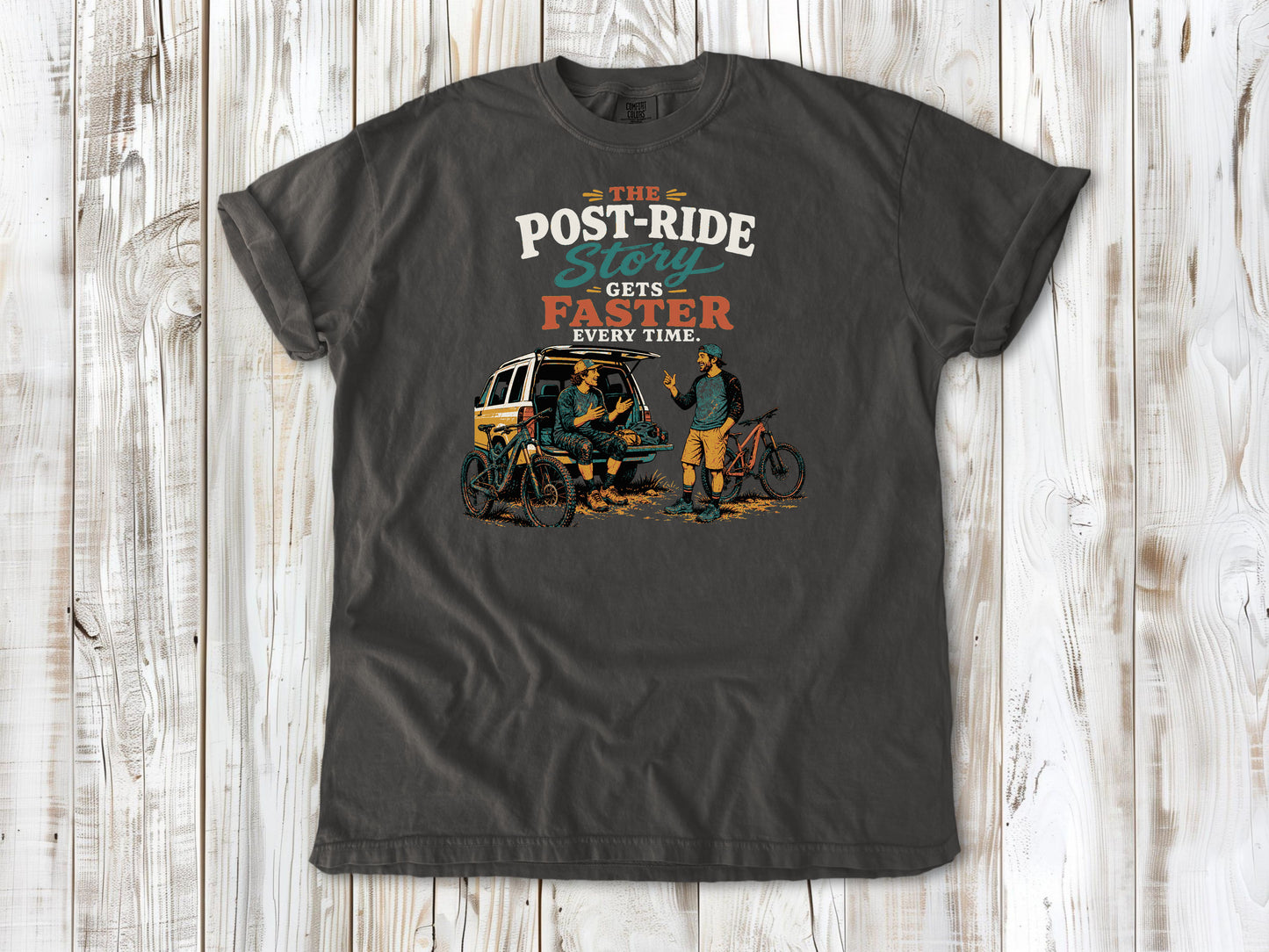 Ivory garment-dyed tee with The Post-Ride Story Gets Faster Every Time mountain bike graphic.