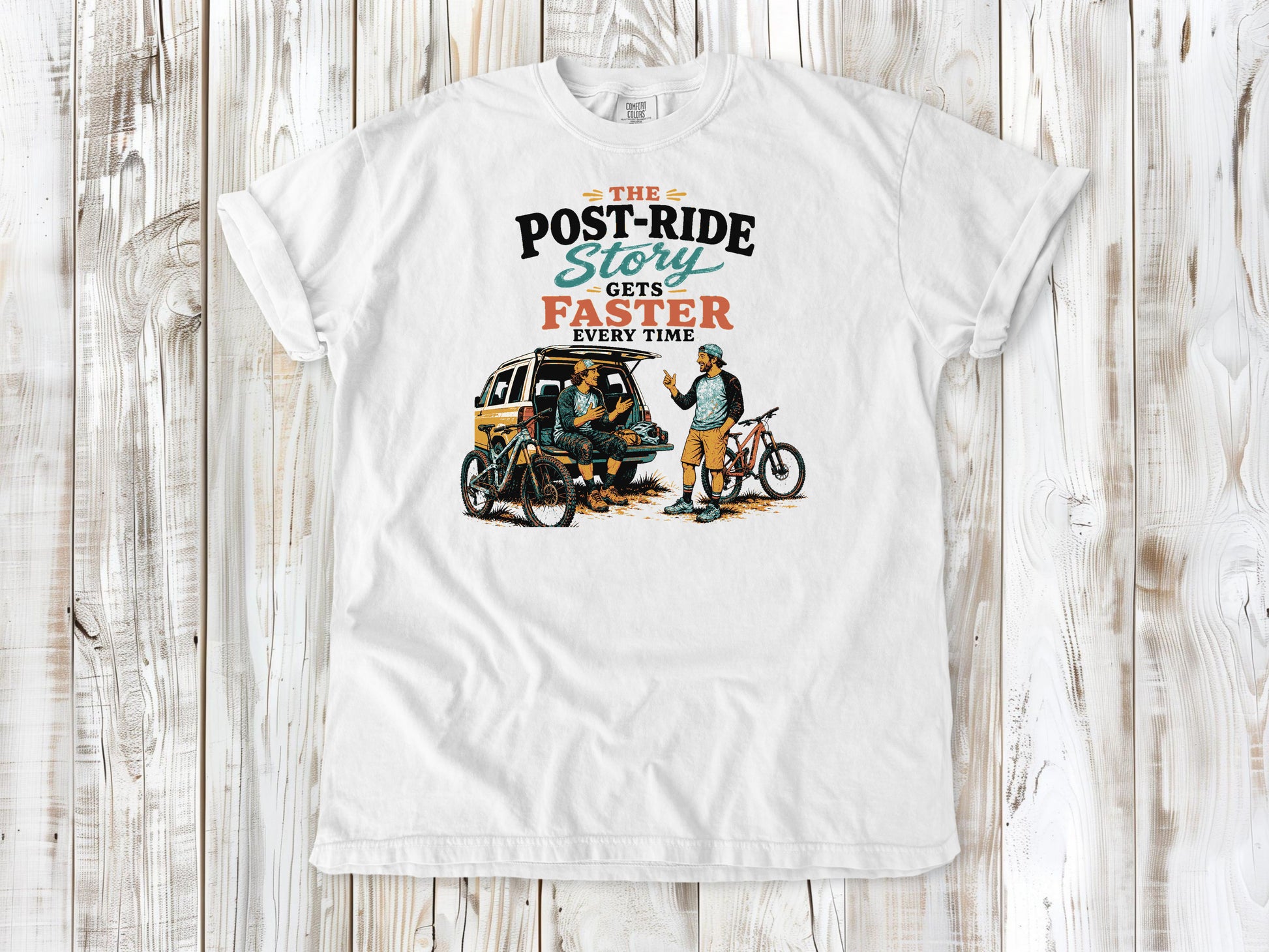 White garment-dyed tee with The Post-Ride Story Gets Faster Every Time mountain bike graphic.