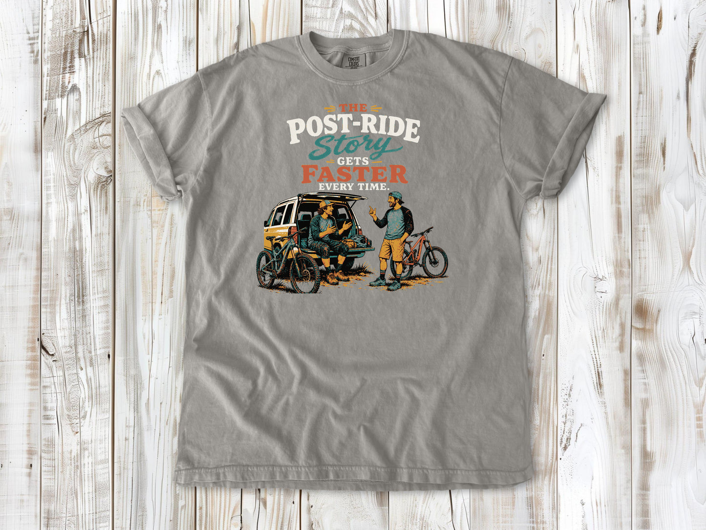 Khaki garment-dyed tee with The Post-Ride Story Gets Faster Every Time mountain bike graphic.