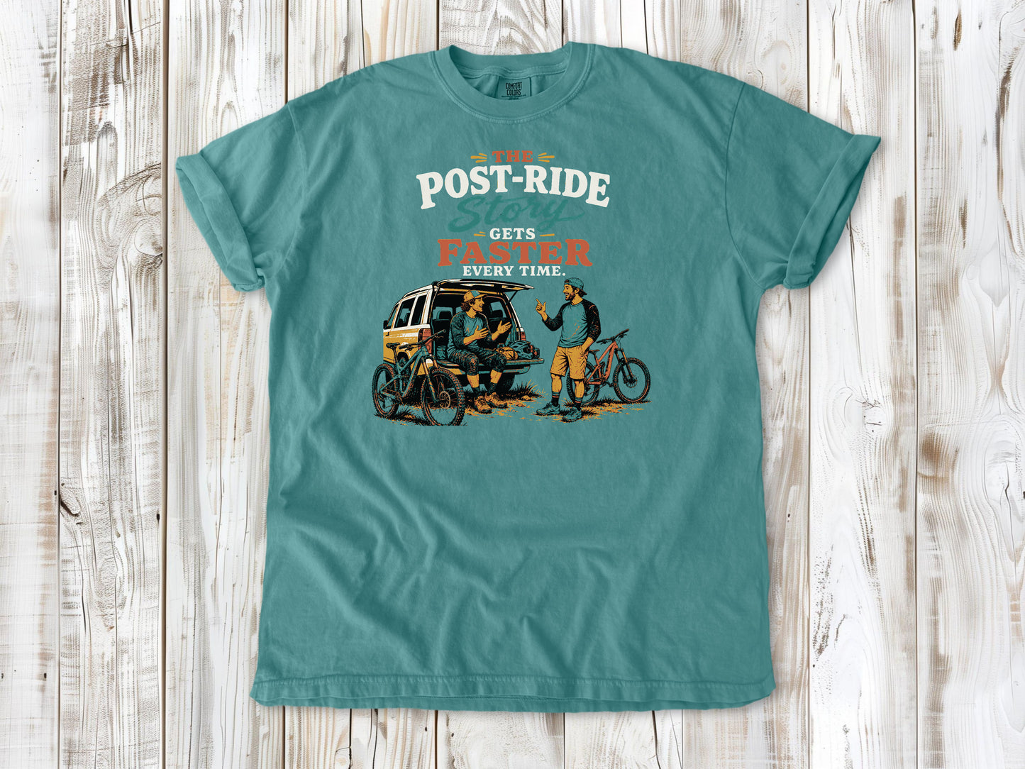 Mustard garment-dyed tee with The Post-Ride Story Gets Faster Every Time mountain bike graphic.