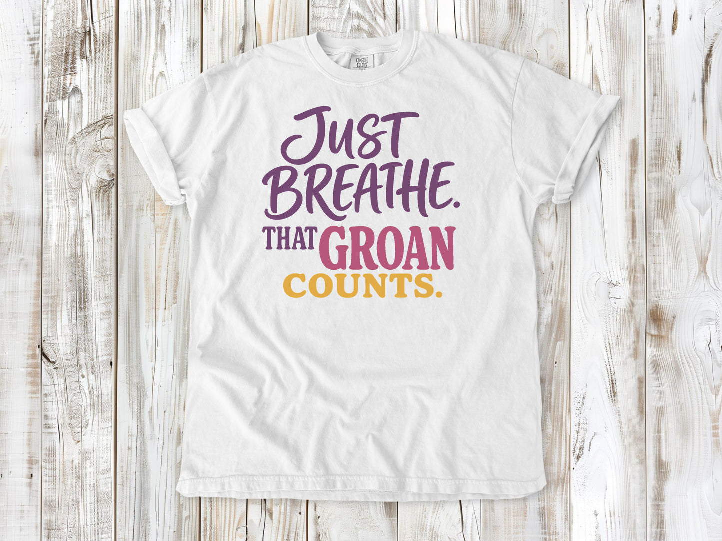 White garment-dyed tee with Just Breathe That Groan Counts yoga graphic.