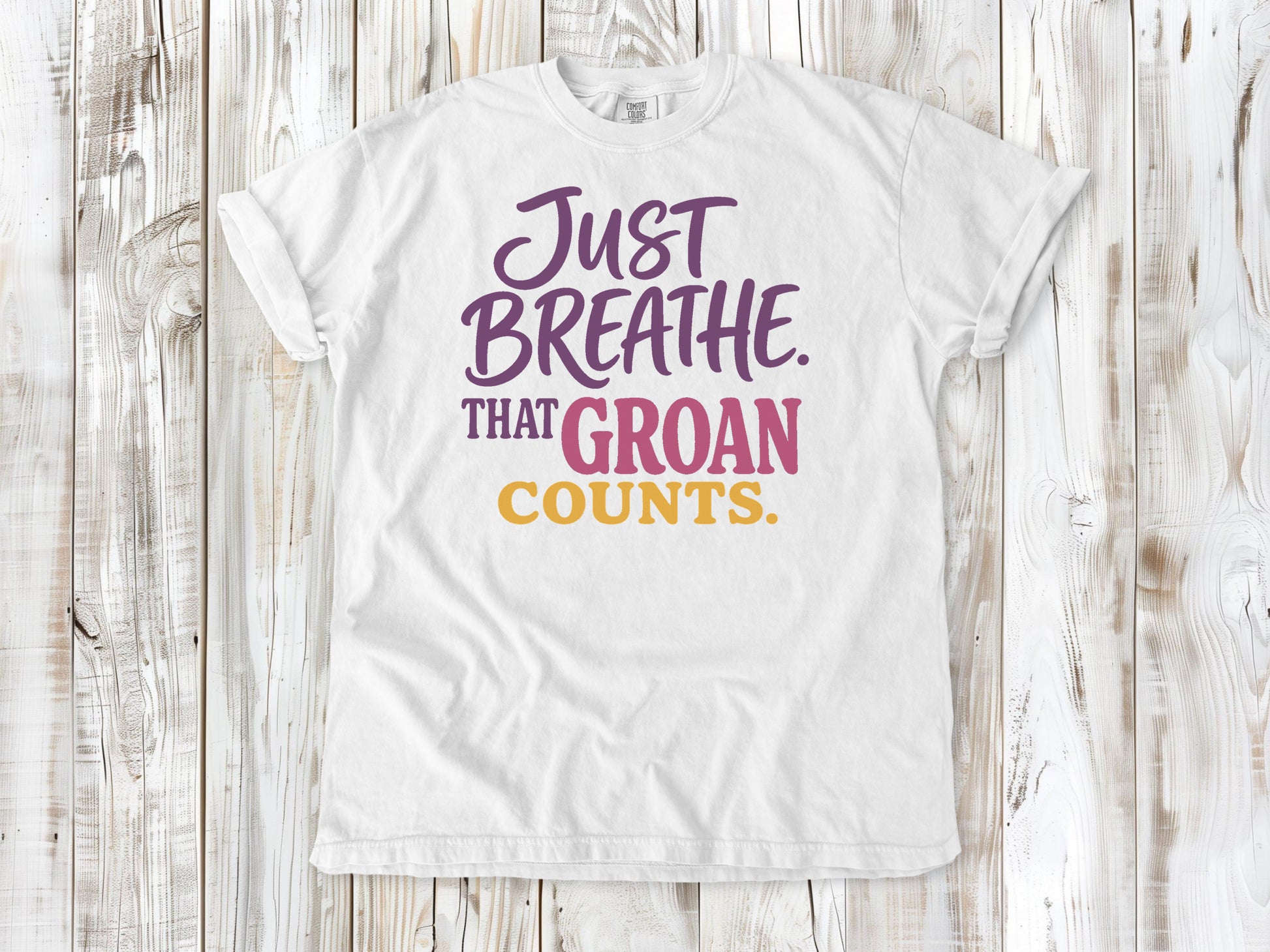 White garment-dyed tee with Just Breathe That Groan Counts yoga graphic.