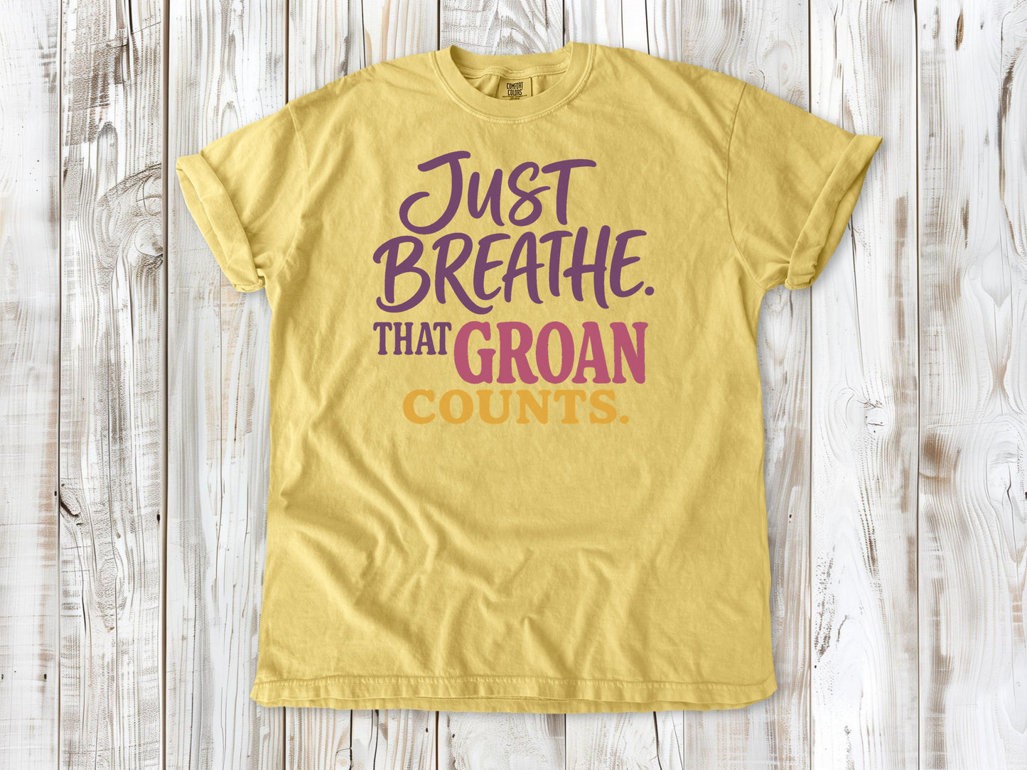 Grey garment-dyed tee with Just Breathe That Groan Counts yoga graphic.