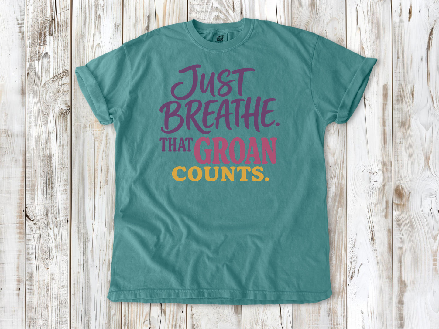 Mustard garment-dyed tee with Just Breathe That Groan Counts yoga graphic.