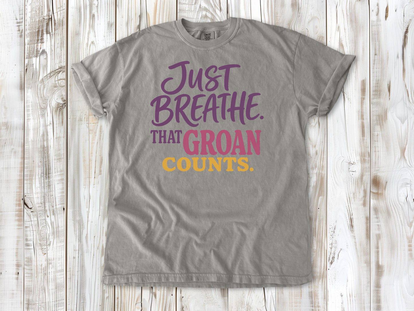 Khaki garment-dyed tee with Just Breathe That Groan Counts yoga graphic.