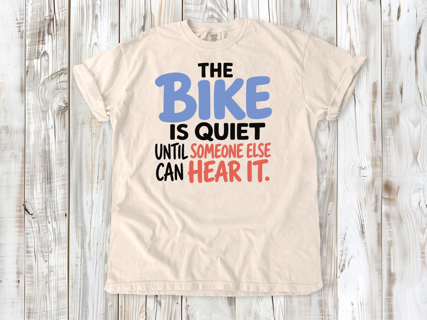 Butter garment-dyed tee with The Bike Is Quiet Until Someone Else Can Hear It cycling graphic.