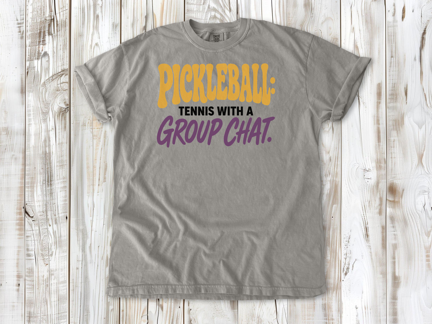 Khaki garment-dyed tee with Pickleball Tennis With a Group Chat graphic.