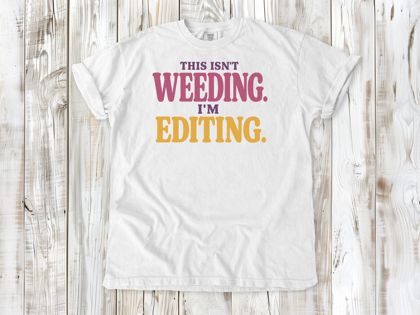 White garment-dyed tee with This Isn't Weeding I'm Editing gardening graphic.