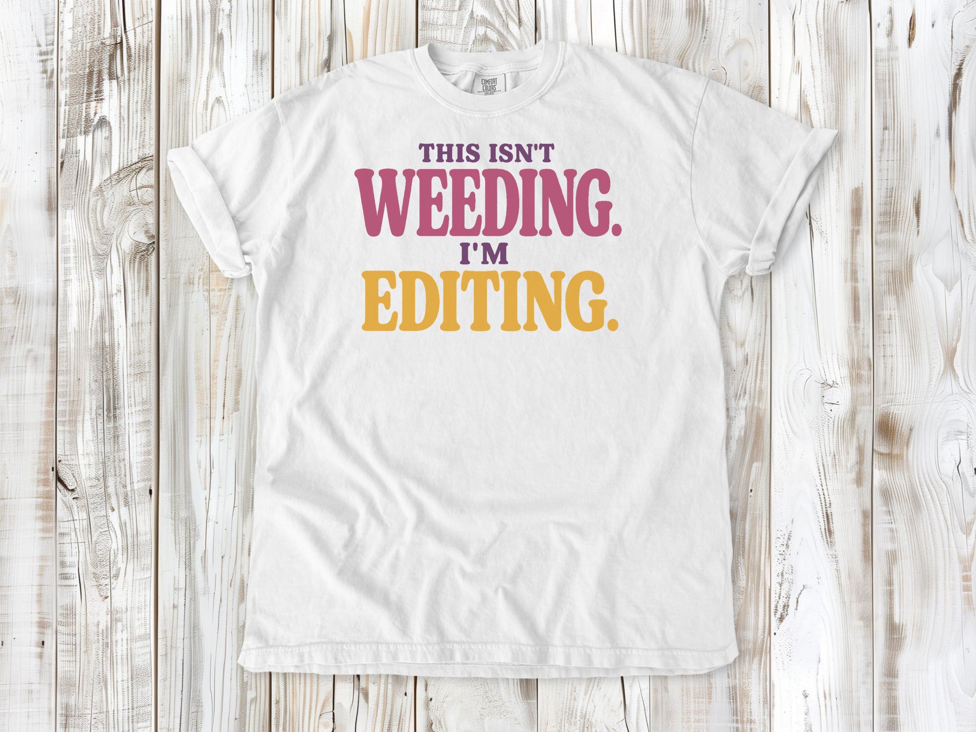 White garment-dyed tee with This Isn't Weeding I'm Editing gardening graphic.