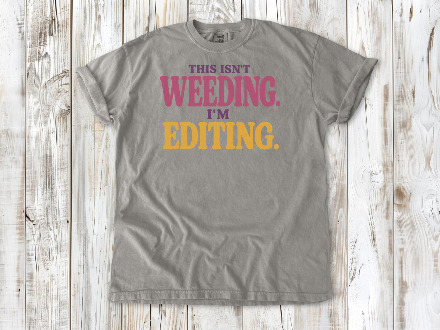 Khaki garment-dyed tee with This Isn't Weeding I'm Editing gardening graphic.