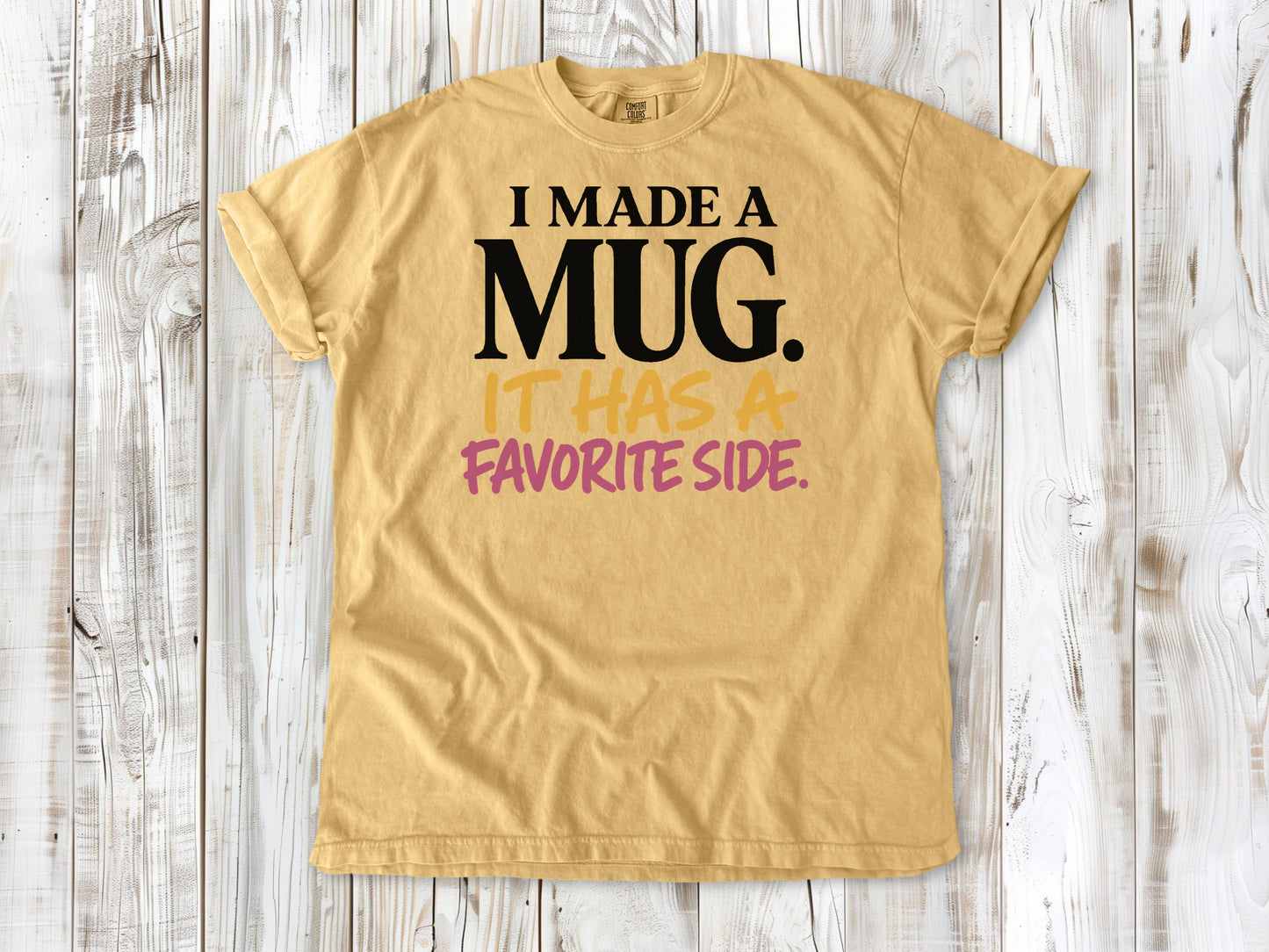Burnt Orange garment-dyed tee with I Made a Mug It Has a Favorite Side pottery graphic.