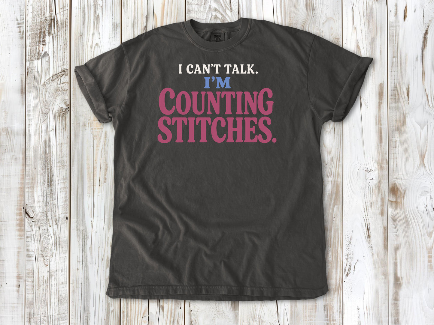 Ivory garment-dyed tee with I Can't Talk I'm Counting Stitches knitting and crochet graphic.