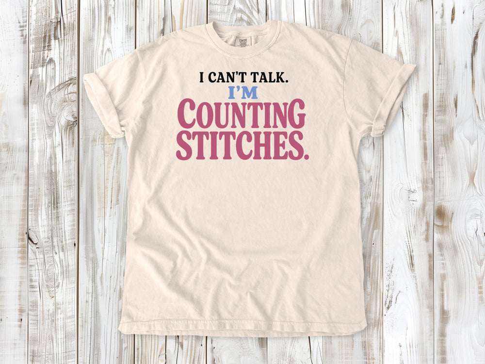 Butter garment-dyed tee with I Can't Talk I'm Counting Stitches knitting and crochet graphic.