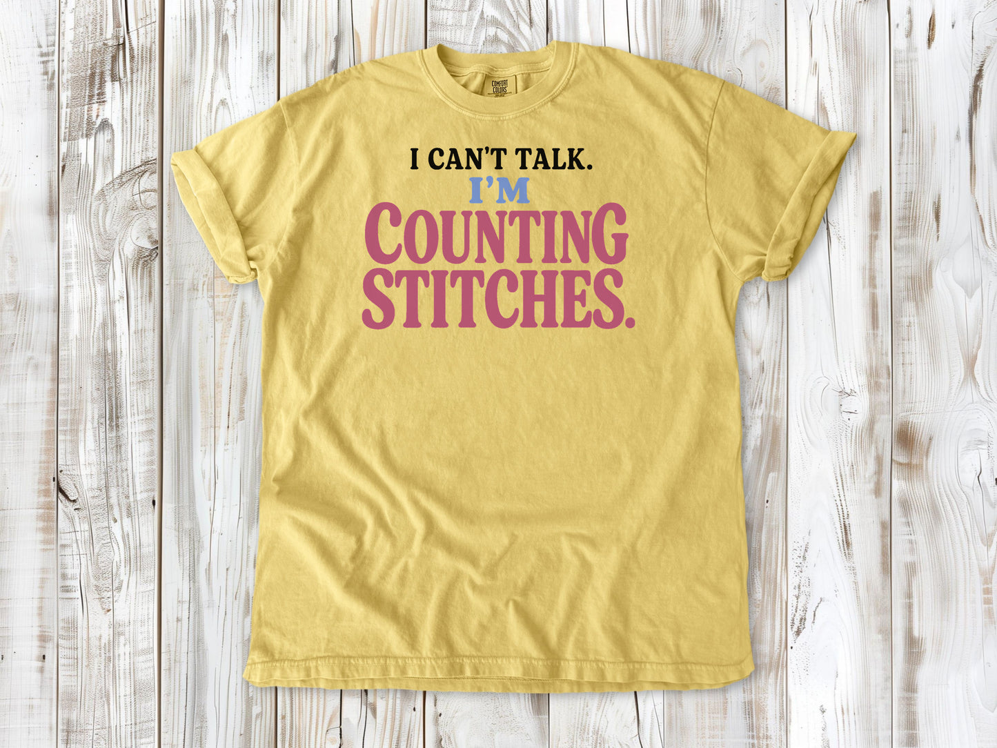 Grey garment-dyed tee with I Can't Talk I'm Counting Stitches knitting and crochet graphic.