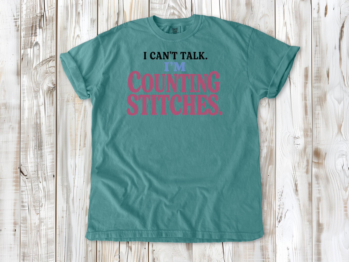 Mustard garment-dyed tee with I Can't Talk I'm Counting Stitches knitting and crochet graphic.