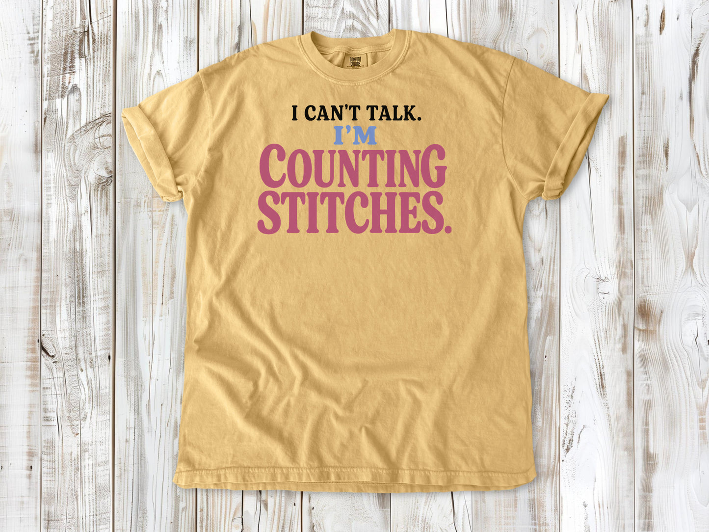 Burnt Orange garment-dyed tee with I Can't Talk I'm Counting Stitches knitting and crochet graphic.