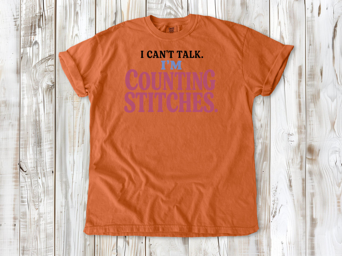 Seafoam garment-dyed tee with I Can't Talk I'm Counting Stitches knitting and crochet graphic.