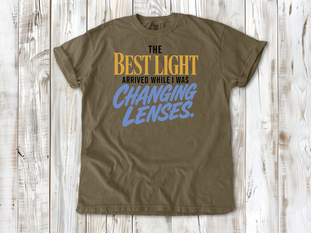 Graphite garment-dyed tee with The Best Light Arrived While I Was Changing Lenses photography graphic.
