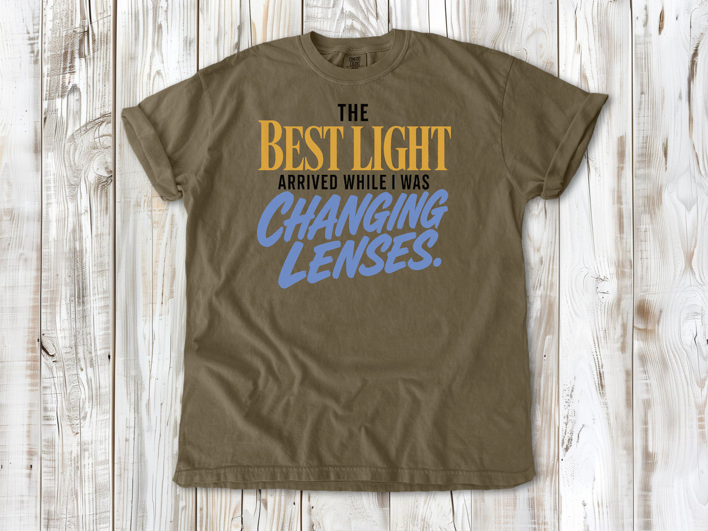 Graphite garment-dyed tee with The Best Light Arrived While I Was Changing Lenses photography graphic.