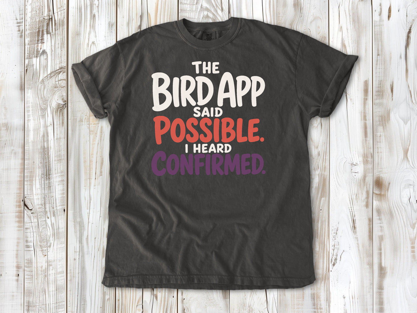 Ivory garment-dyed tee with The Bird App Said Possible I Heard Confirmed birding graphic.