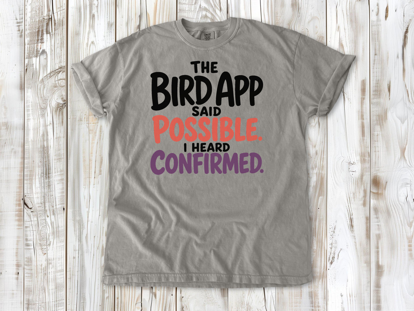 Khaki garment-dyed tee with The Bird App Said Possible I Heard Confirmed birding graphic.