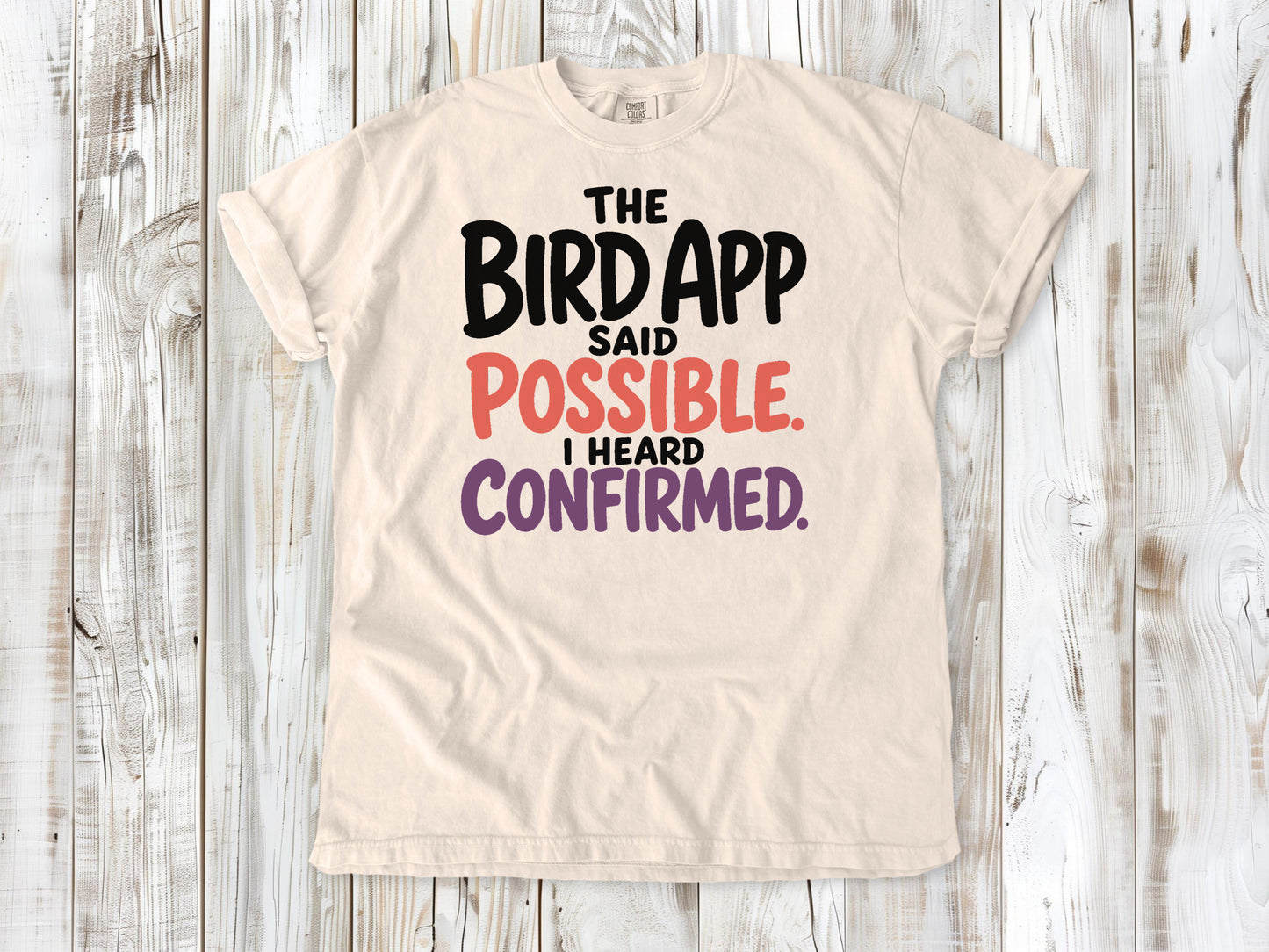 Butter garment-dyed tee with The Bird App Said Possible I Heard Confirmed birding graphic.