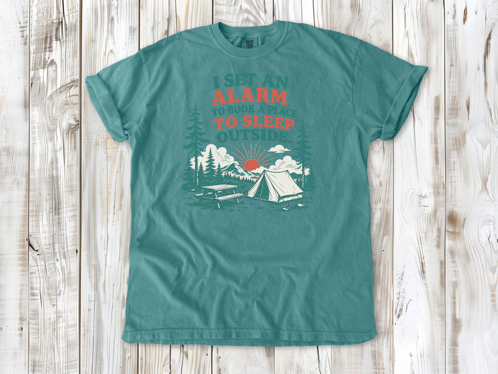 Seafoam garment-dyed tee with I Set an Alarm to Book a Place to Sleep Outside camping graphic.