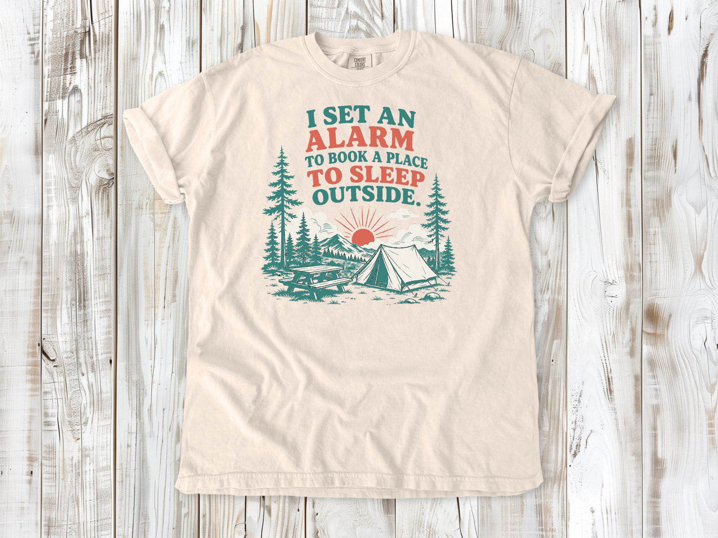 Ivory garment-dyed tee with I Set an Alarm to Book a Place to Sleep Outside camping graphic.