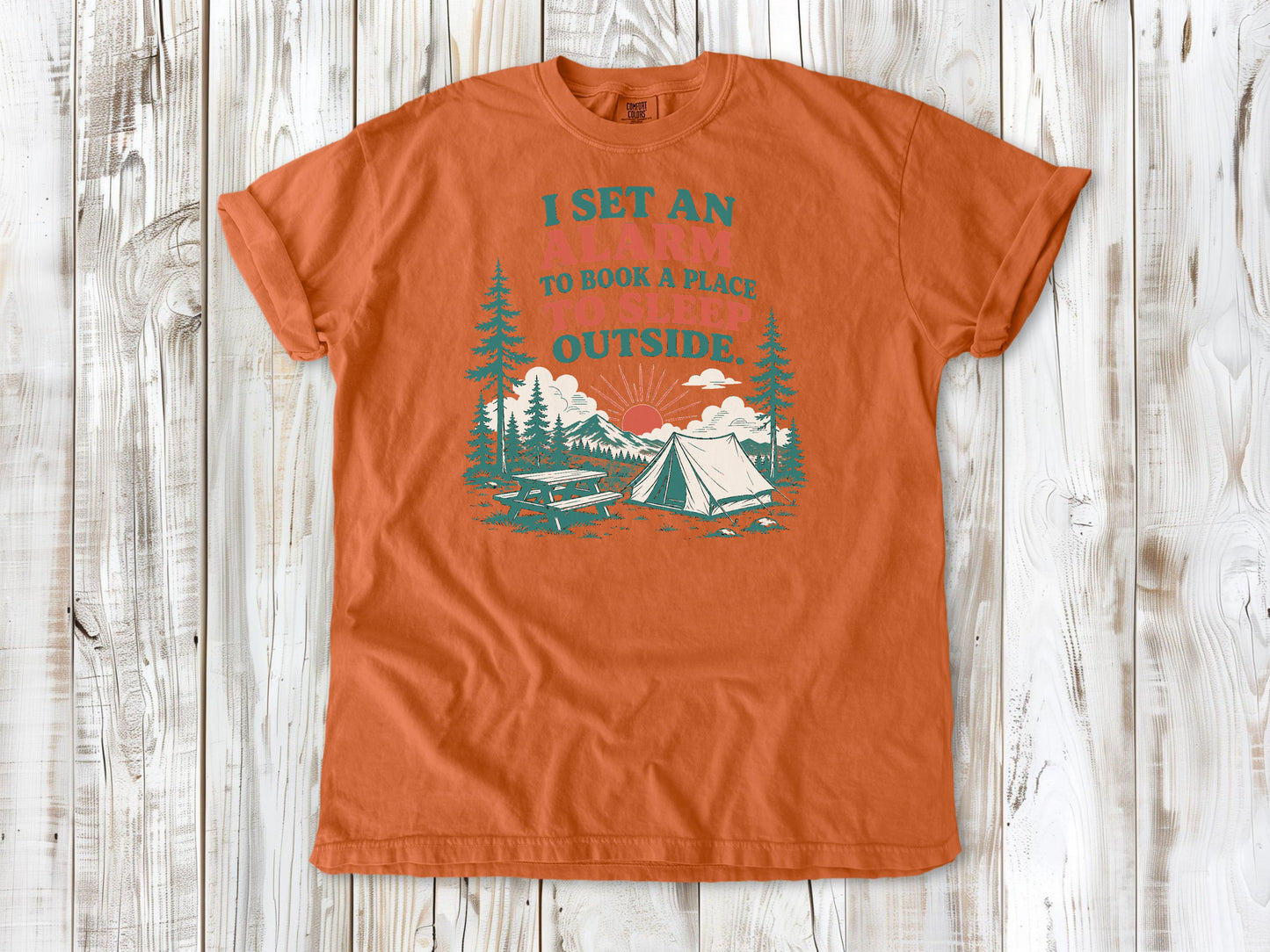 Burnt Orange garment-dyed tee with I Set an Alarm to Book a Place to Sleep Outside camping graphic.