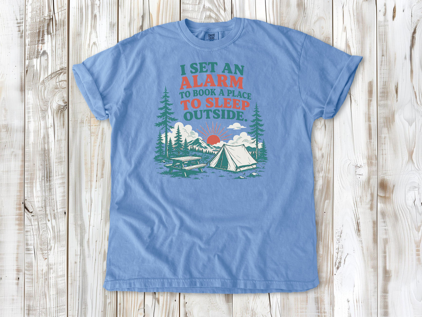 Washed Denim garment-dyed tee with I Set an Alarm to Book a Place to Sleep Outside camping graphic.