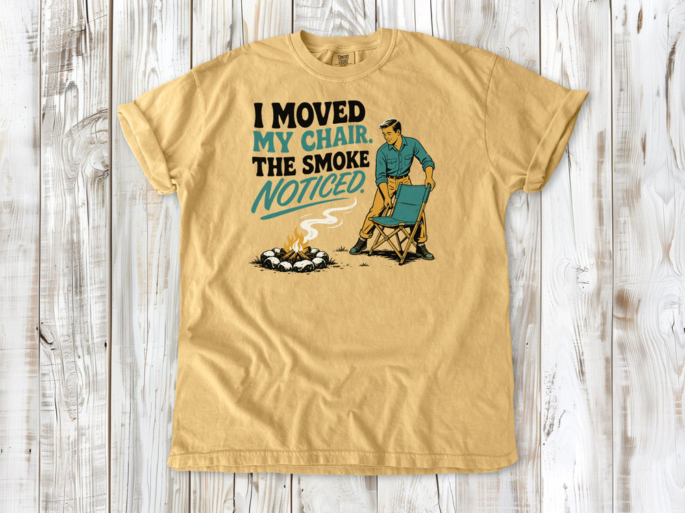 Burnt Orange garment-dyed tee with I Moved My Chair The Smoke Noticed campfire graphic.