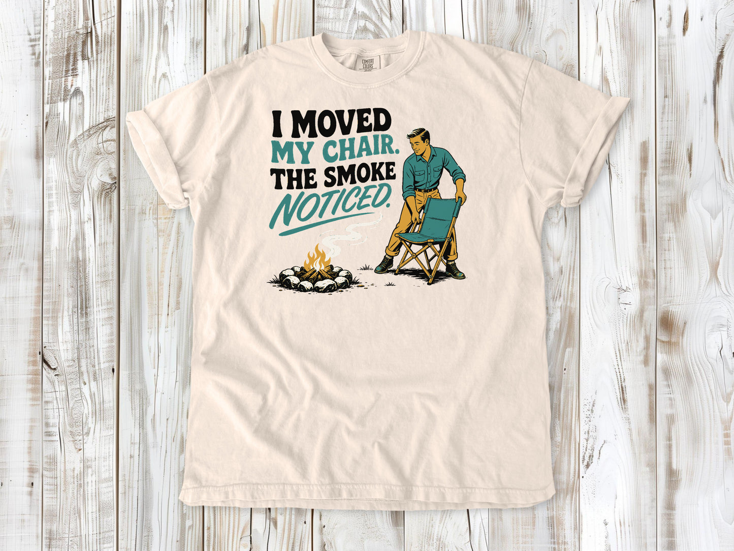 Butter garment-dyed tee with I Moved My Chair The Smoke Noticed campfire graphic.