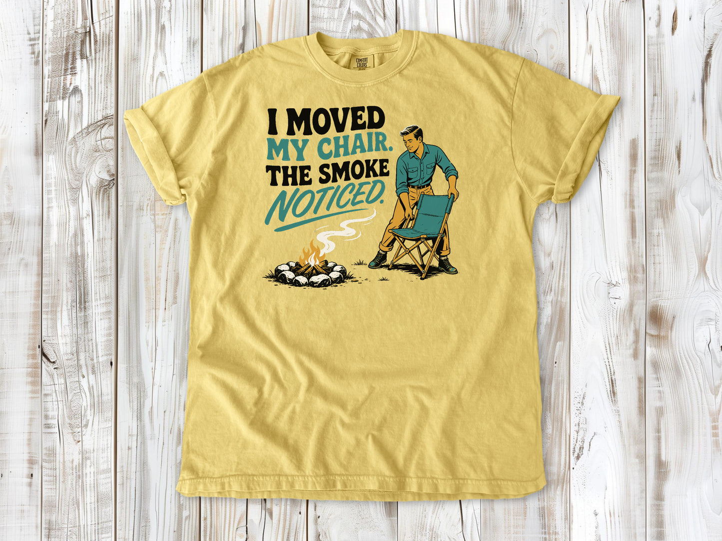 Grey garment-dyed tee with I Moved My Chair The Smoke Noticed campfire graphic.