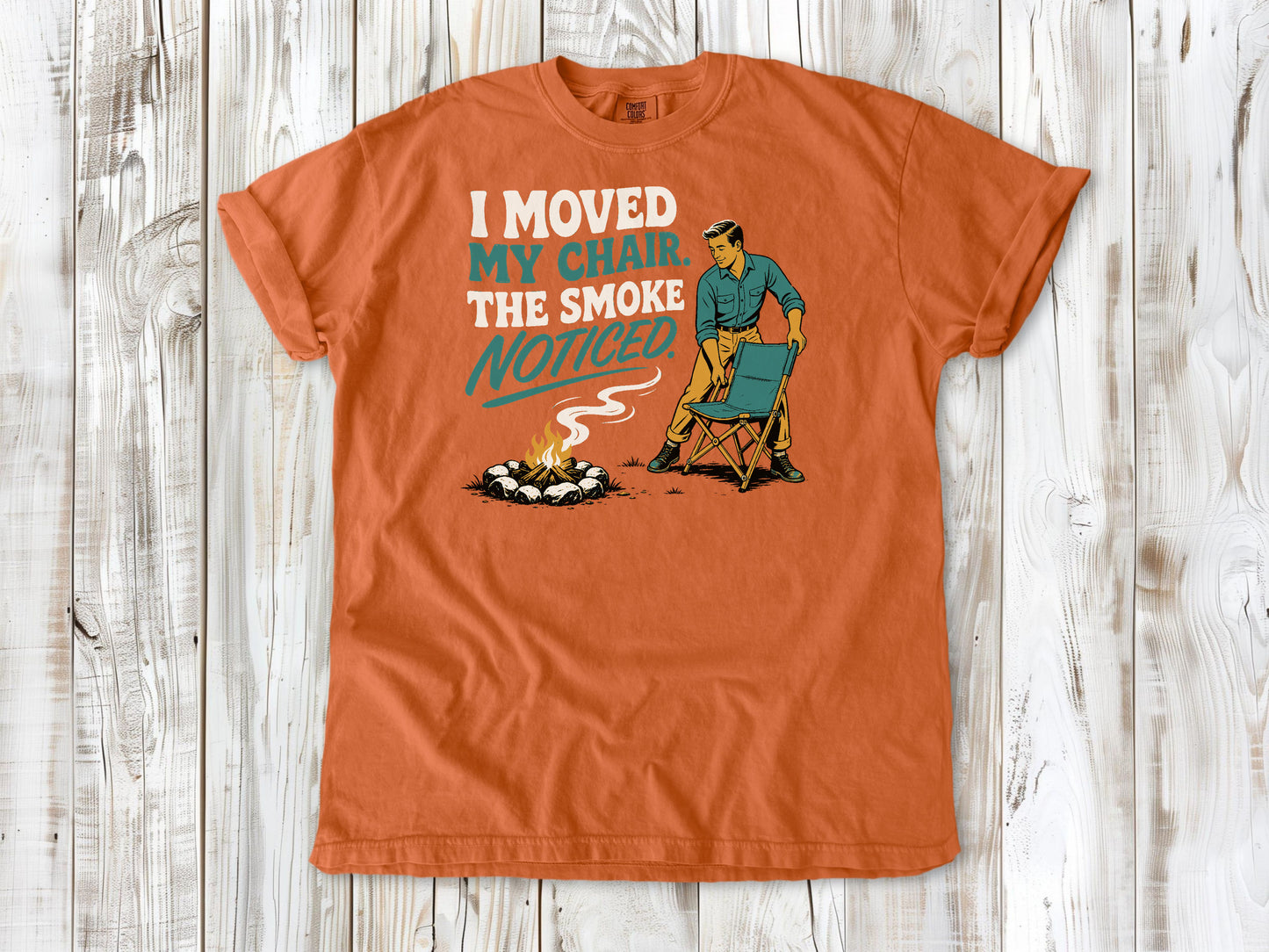 Seafoam garment-dyed tee with I Moved My Chair The Smoke Noticed campfire graphic.