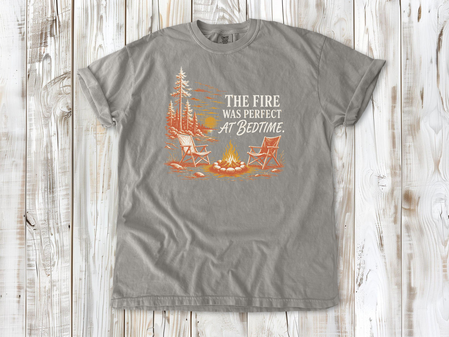 Khaki garment-dyed tee with The Fire Was Perfect at Bedtime campfire graphic.