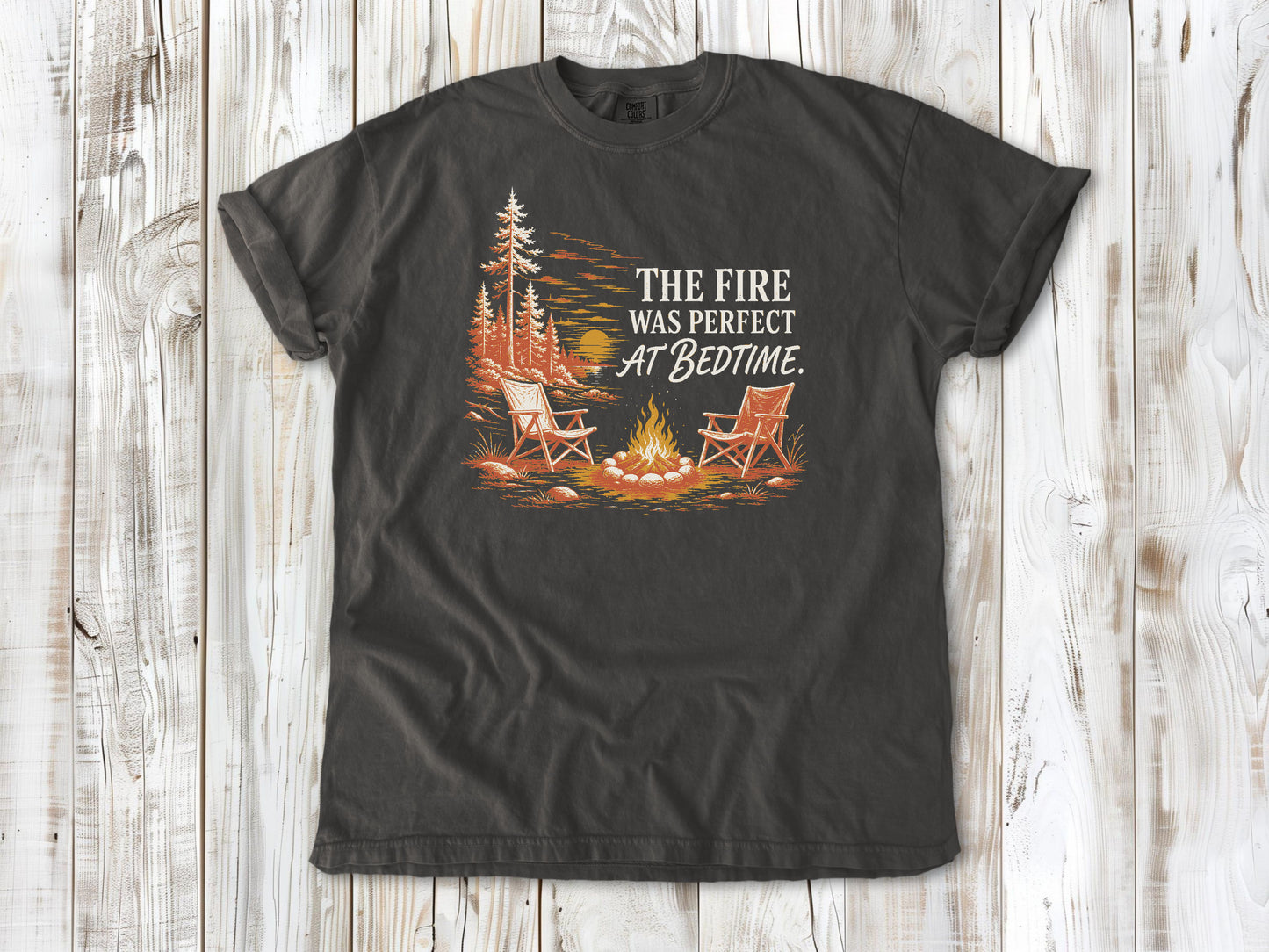 Ivory garment-dyed tee with The Fire Was Perfect at Bedtime campfire graphic.