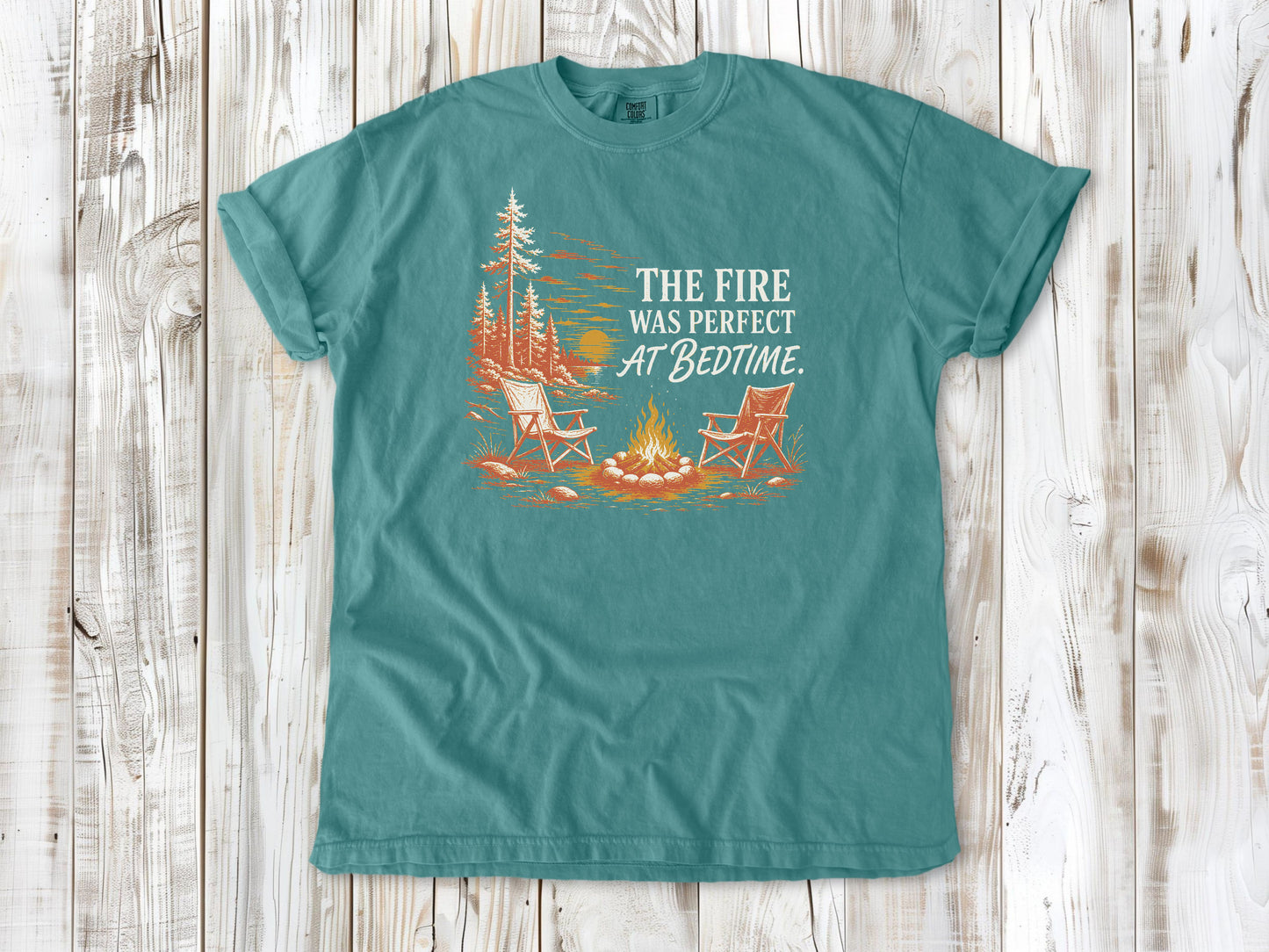 Mustard garment-dyed tee with The Fire Was Perfect at Bedtime campfire graphic.