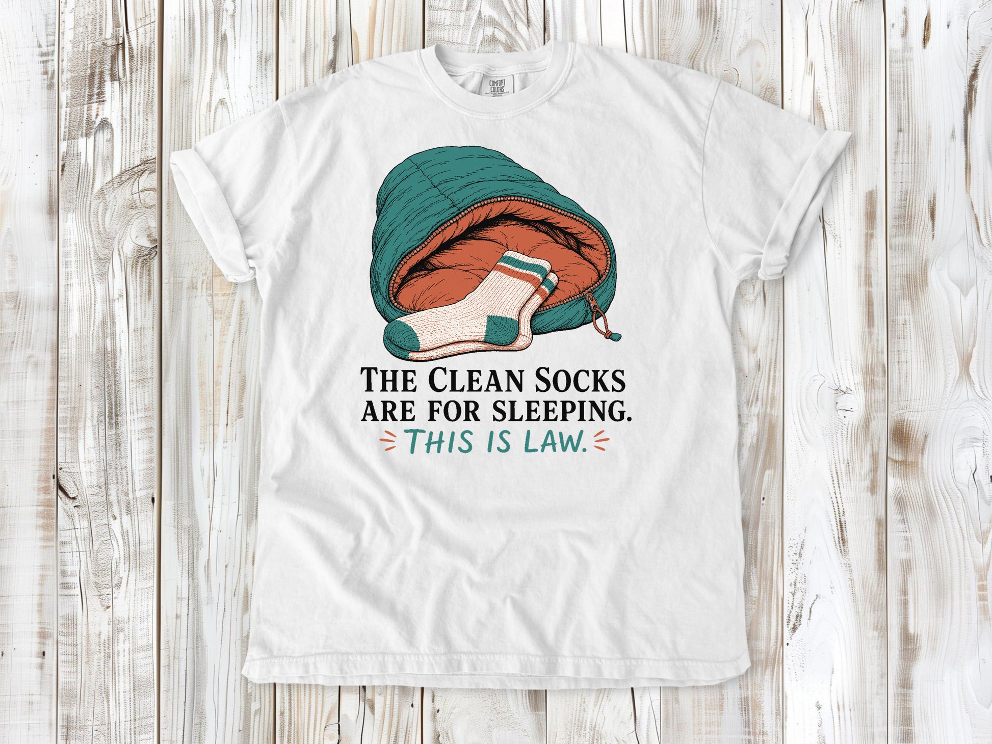 White garment-dyed tee with The Clean Socks Are for Sleeping This Is Law camping graphic.