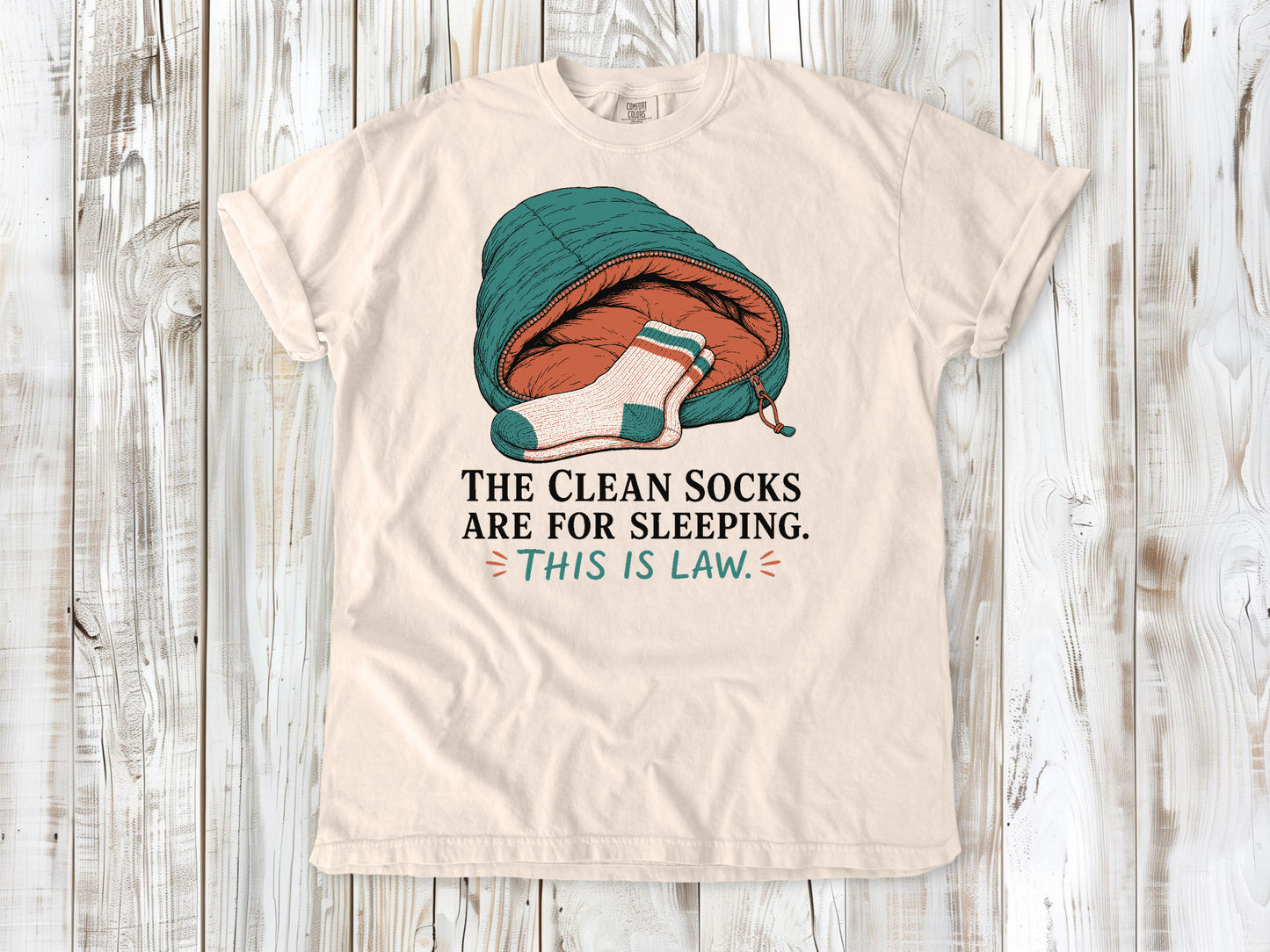 Butter garment-dyed tee with The Clean Socks Are for Sleeping This Is Law camping graphic.