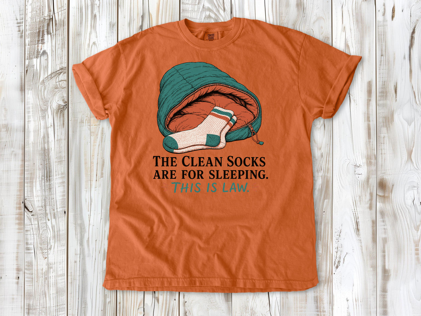 Seafoam garment-dyed tee with The Clean Socks Are for Sleeping This Is Law camping graphic.