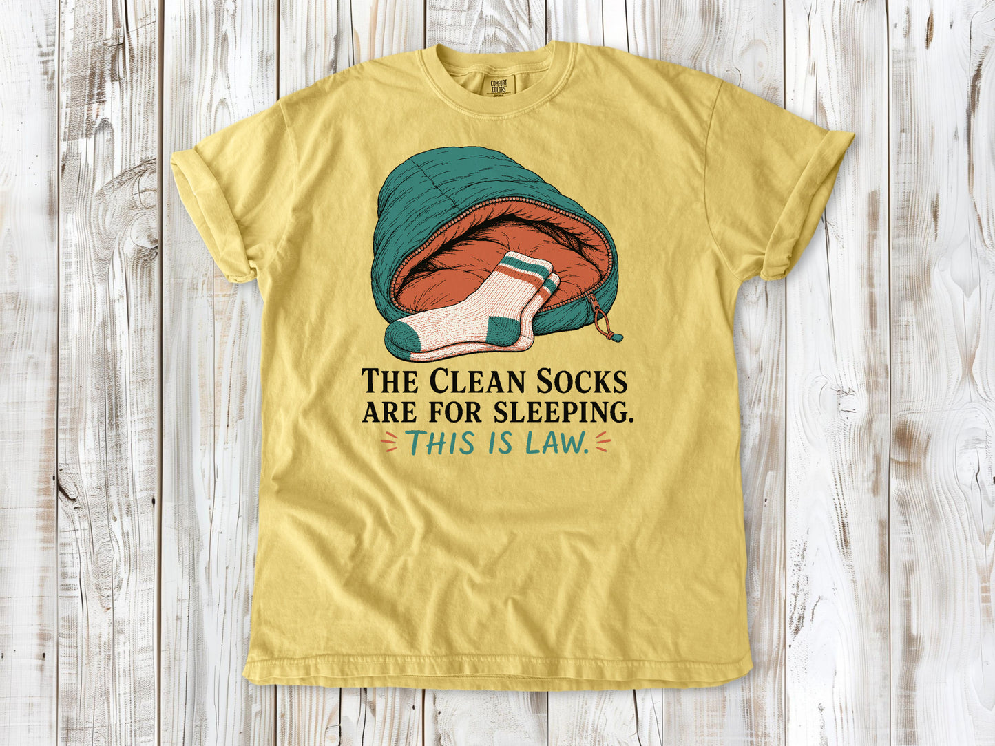 Grey garment-dyed tee with The Clean Socks Are for Sleeping This Is Law camping graphic.