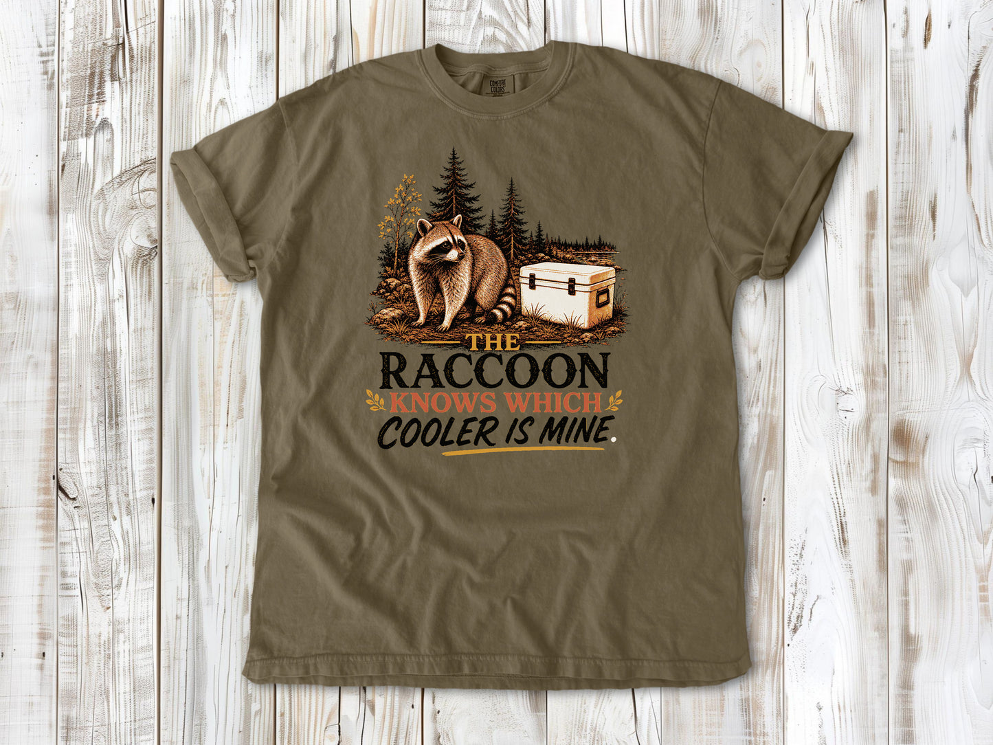 Graphite garment-dyed tee with The Raccoon Knows Which Cooler Is Mine camping graphic.