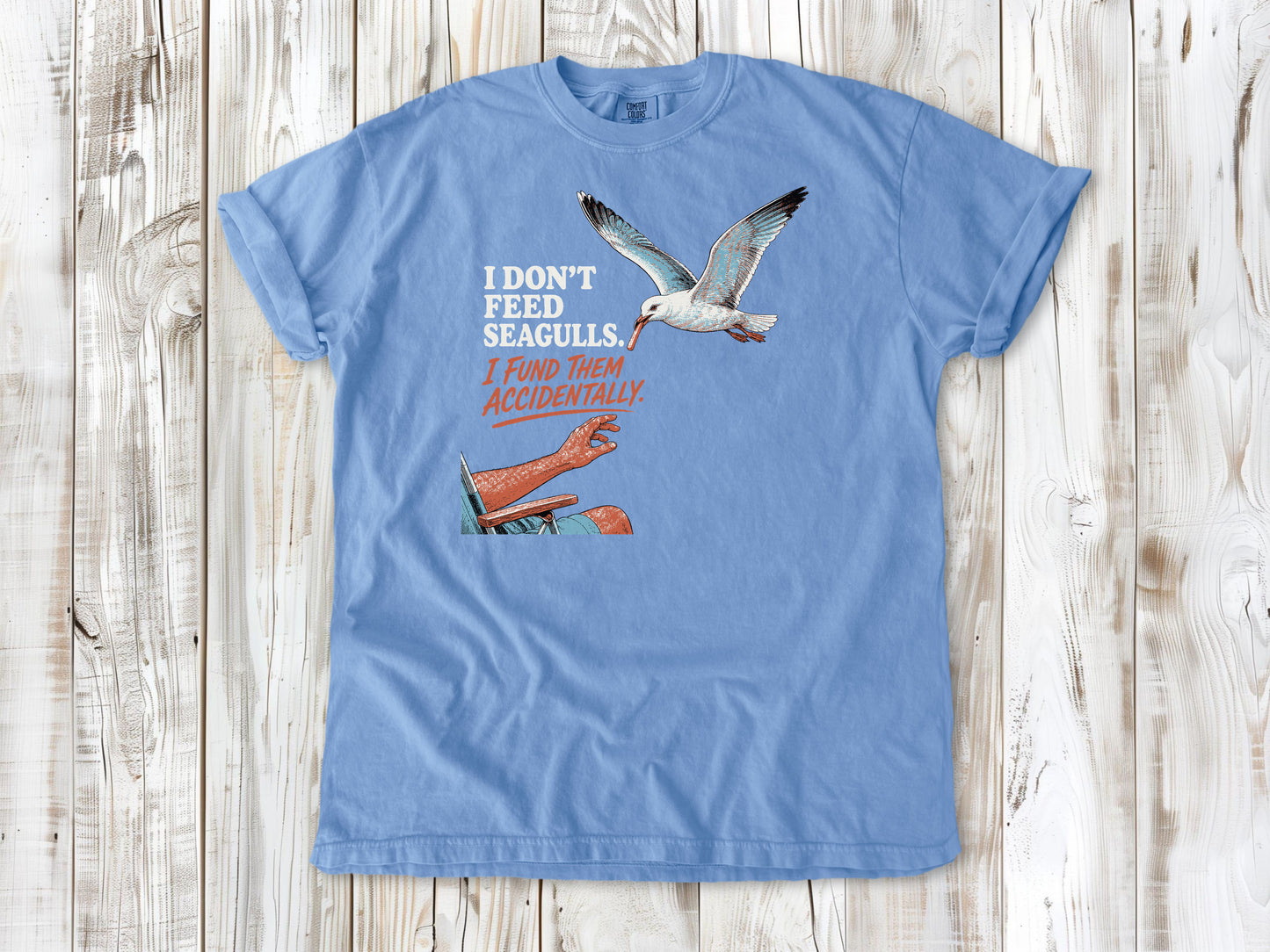 Pepper garment-dyed tee with I Don't Feed Seagulls I Fund Them Accidentally beach graphic.