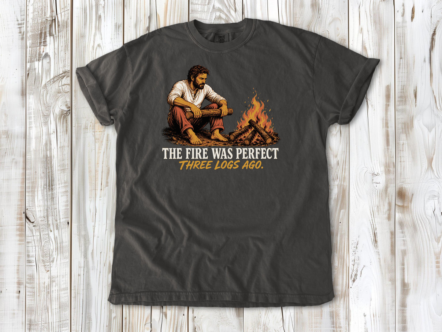Ivory garment-dyed tee with The Fire Was Perfect Three Logs Ago beach bonfire graphic.