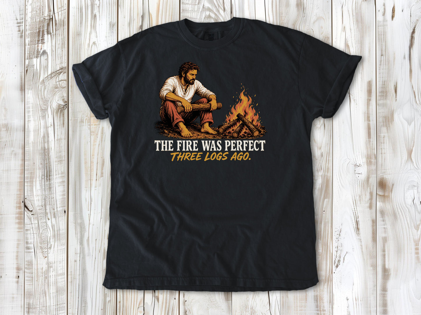 Washed Denim garment-dyed tee with The Fire Was Perfect Three Logs Ago beach bonfire graphic.