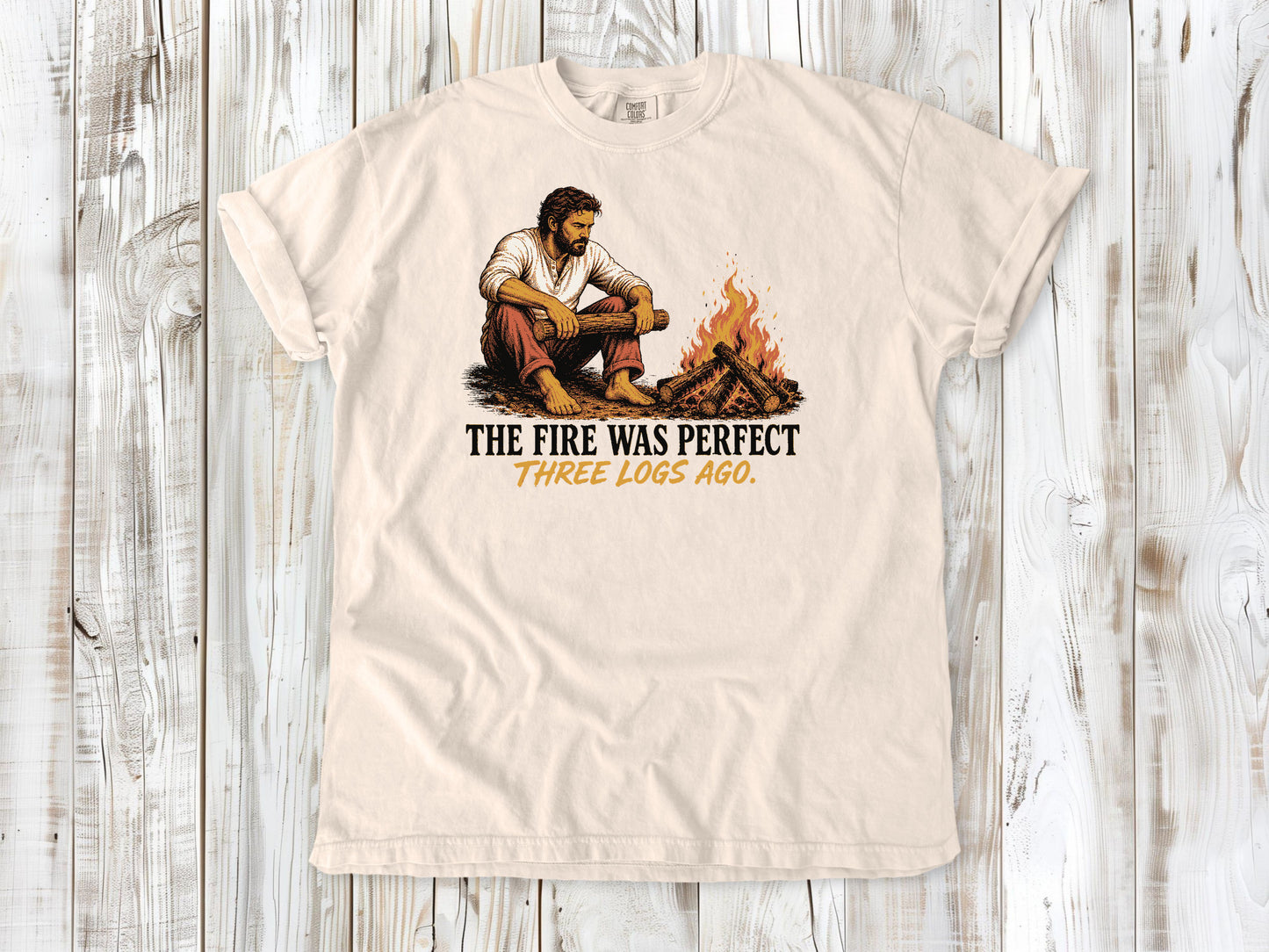 Butter garment-dyed tee with The Fire Was Perfect Three Logs Ago beach bonfire graphic.