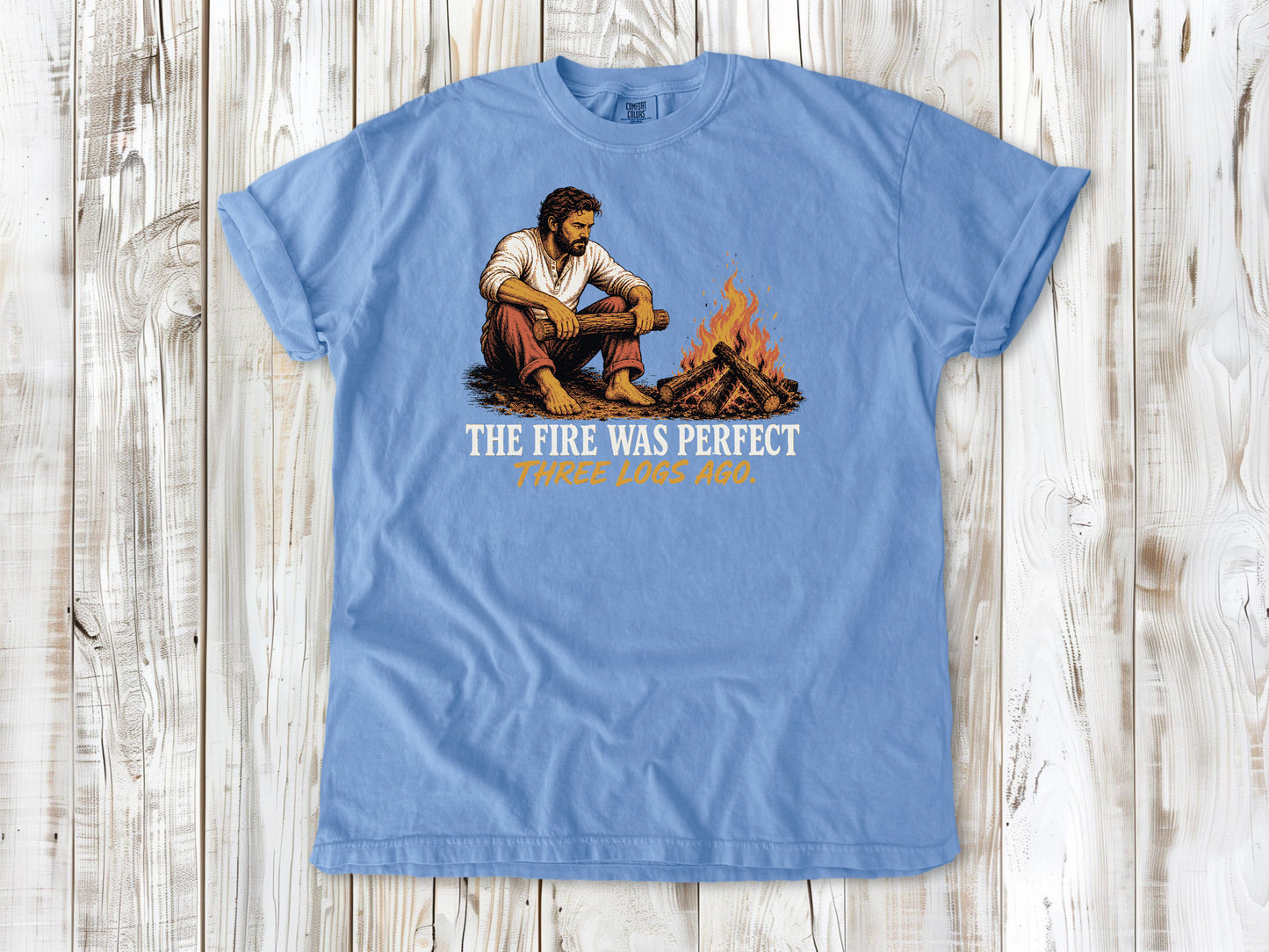 Pepper garment-dyed tee with The Fire Was Perfect Three Logs Ago beach bonfire graphic.